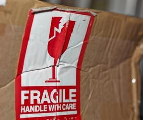 damaged shipping box with fragile sticker